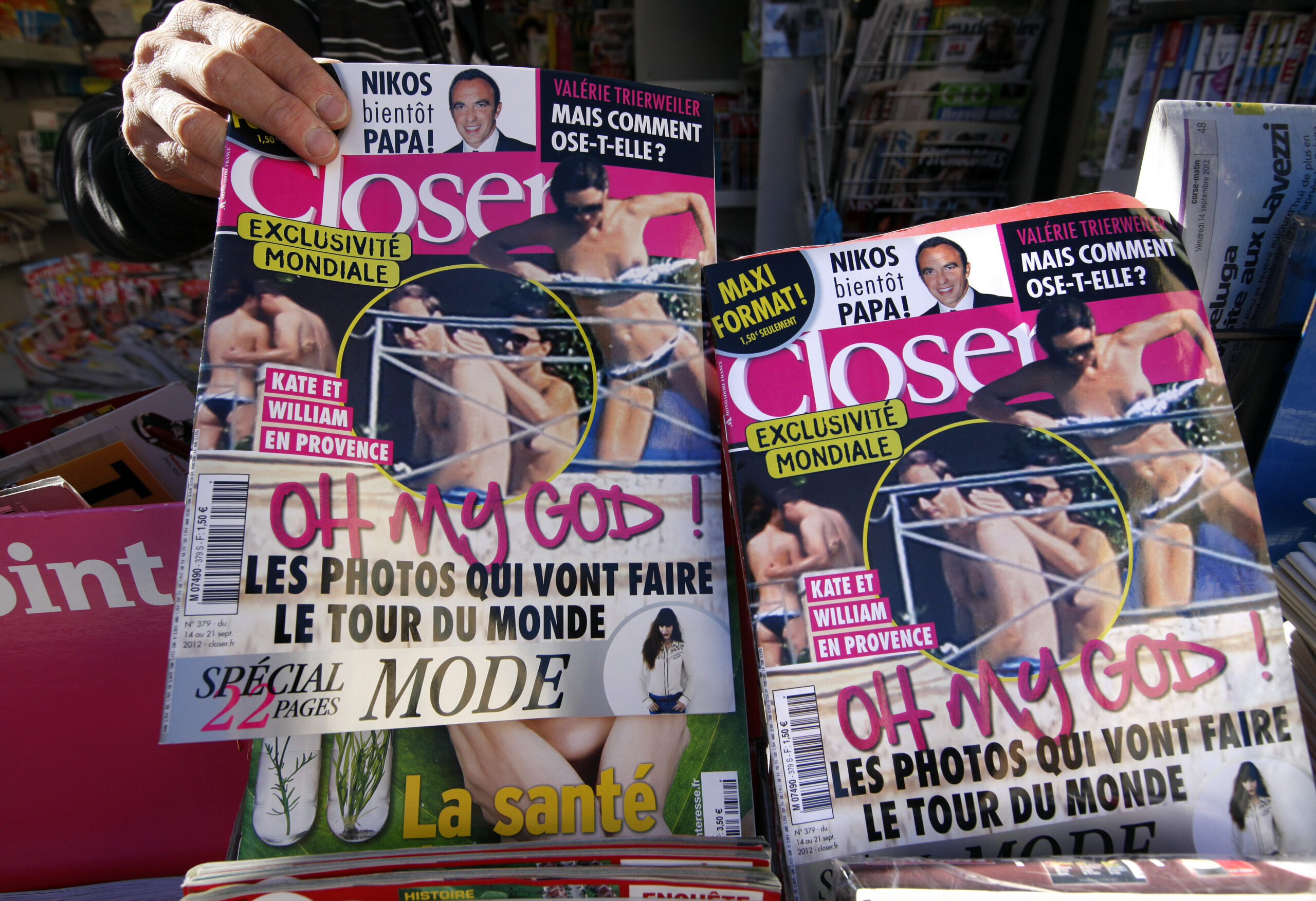 A man holds a copy of the French magazine Closer showing pictures of Catherine, Duchess of Cambridge, and Britain's Prince William are displayed in a newspaper kiosk in Nice. (Eric Gaillard/Reuters)