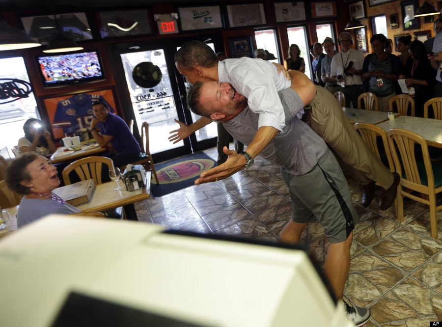 President Barack Obama, right, is picked-up and lifted off the ground by Scott Van Duzer, left, owner of Big Apple Pizza and Pasta Italian Restaurant during an unannounced stop, Sunday, Sept. 9, 2012, in Ft. Pierce, Fla. (AP Photo/Pablo Martinez Monsivais) (Associated Press)