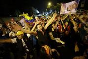 Supporters of Venezuela's President Hugo Chavez cheer after polling stations closed and before any results were made available. (AP Photo/ Fernando Llano)