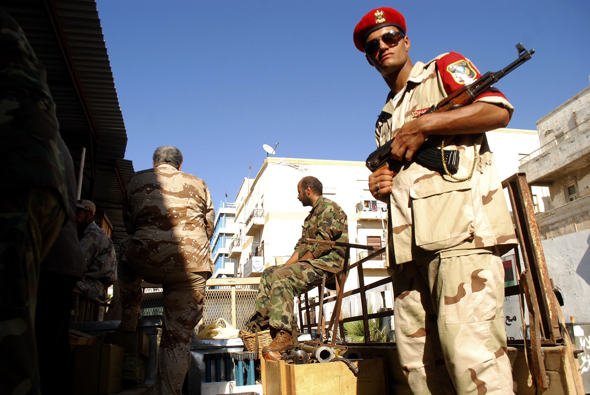 Libyan security forces stand guard as people turn in weapons in Benghazi, Libya. (AP/Ibrahim Alaguri)
