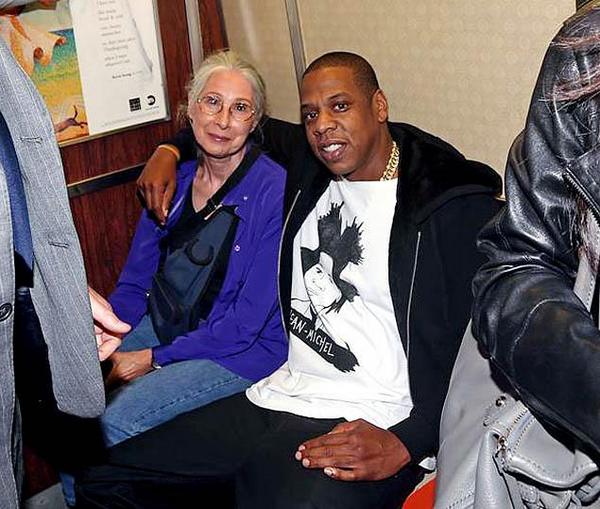 Jay-Z poses with a woman on the R train before Saturday night's performance (Lawrence Scwartzwald/Splash News)