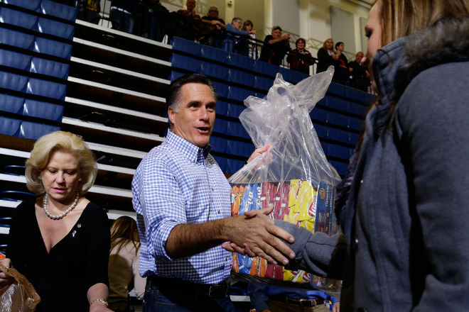 Mitt Romney accepts donations of food as he participates in an Ohio campaign event collecting supplies for victims of Hurricane Sandy. (AP/Charles Dharapak)