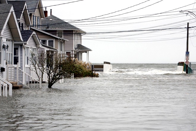 High tide begins to flood a street on the shoreline area of Milford, Conn., as Hurricane Sandy approaches Oct. 29, 2012. (Reuters/Michelle Mcloughlin)