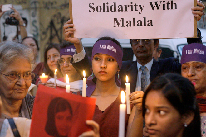 Pakistanis hold candles during a protest to condemn the attack on 14-year-old schoolgirl Malala Yousufzai, who was shot on Tuesday by the Taliban for speaking out in support of education for women, in Karachi, Pakistan, Oct. 11, 2012. (AP/Shakil Adil)
