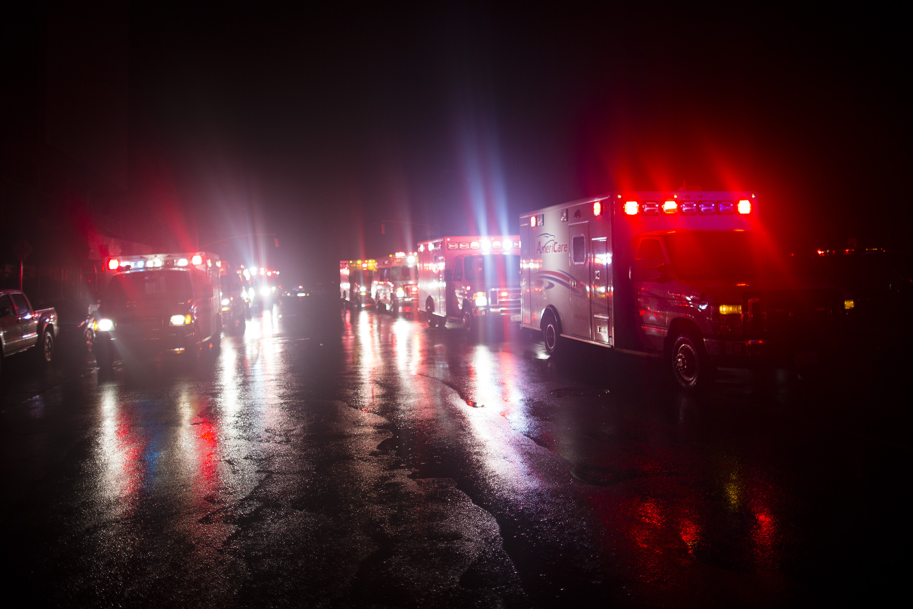 Ambulances wait outside New York University Tisch Hospital during an evacuation of the hospital after its backup generator failed . (AP/John Minchillo)