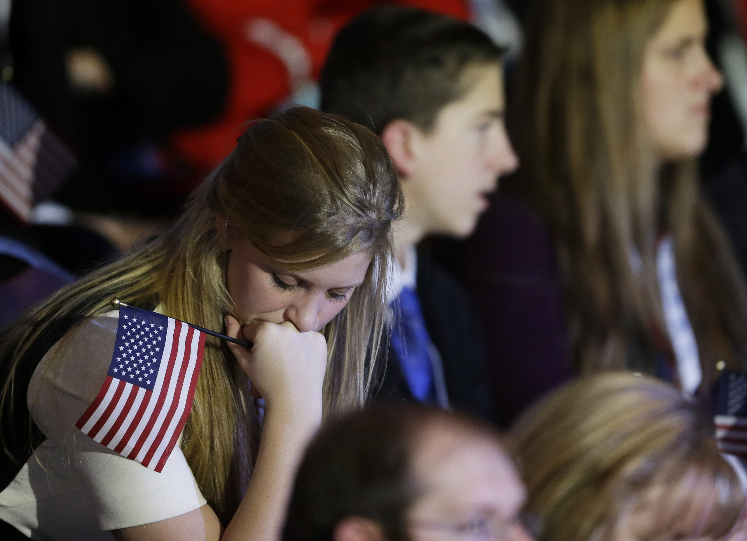 A supporter reacts to voting results displayed on a television screen during Republican presidential candidate and former Massachusetts Gov. Mitt Romney's election night rally. (AP/David Goldman)