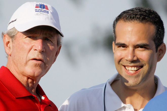 Former President George W. Bush, left, talks with talks with his nephew George P. Bush during the Bush Center Warrior Open in Irving, Texas,  Sept. 24, 2012. (AP/Lm Otero)