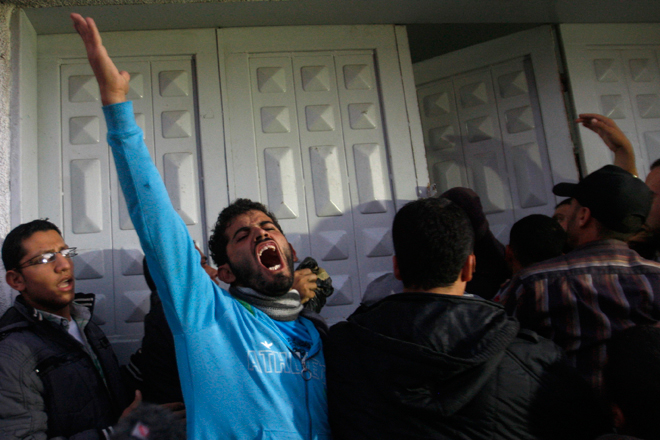 Palestinian men react at hospital after the body of Ahmed Jabari, head of the Hamas military wing, was brought,  in Gaza City, Wednesday, Nov. 14, 2012. (AP/Hatem Moussa)