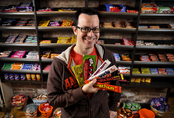 Jason Liebig holds a few pieces from his candy wrapper collection in the London Candy Company on the Upper East Side. Photos by Brad Horrigan.