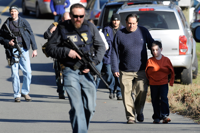 Parents leave after being reunited with their children following a shooting at the Sandy Hook Elementary School in Newtown, Conn., Friday. (AP/Jessica Hill)