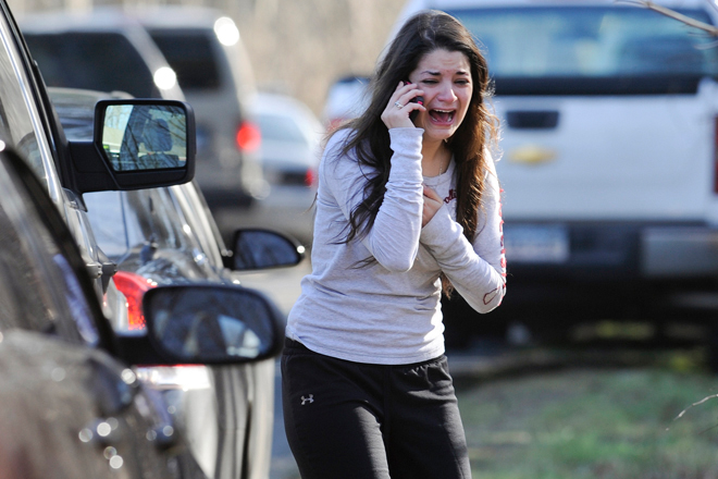 A woman waits to hear about her sister, a teacher, following a shooting at the Sandy Hook Elementary School in Newtown, Conn., Friday, Dec. 14, 2012. (AP/Jessica Hill)