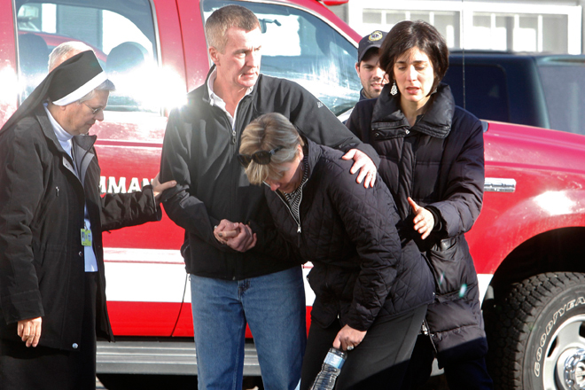 Relatives react outside Sandy Hook Elementary School following a shooting in Newtown, Connecticut, December 14, 2012. (Reuters/Michelle Mcloughlin)