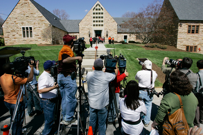 Members of the media photograph mourners as they emerge from Blacksburg Presbyterian Church after the memorial service for Virginia Tech shooting victim Kevin P. Granata in Blacksburg, Va., Friday, April 20, 2007. The service was closed to media cameras at the request of the family. (AP/Charles Dharapak)