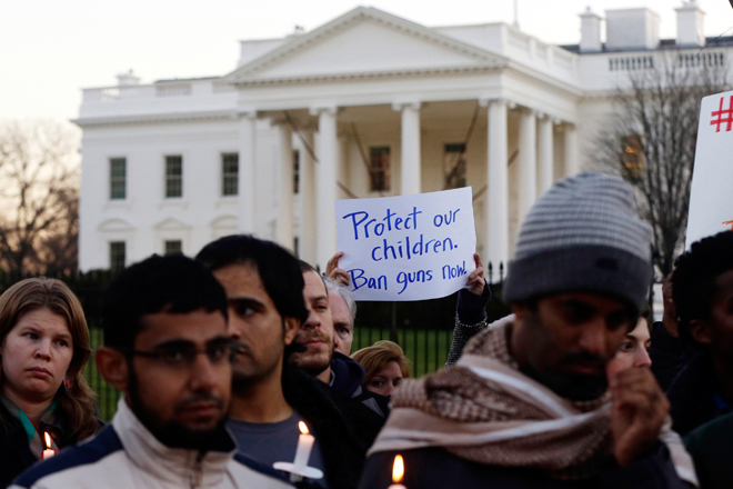 Supporters of gun control gather on Pennsylvania Avenue in front of the White House in Washington, Friday, Dec. 14, 2012, during a vigil for the victims of the shooting at Sandy Hook Elementary School in Newtown, CT. (AP/Charles Dharapak)