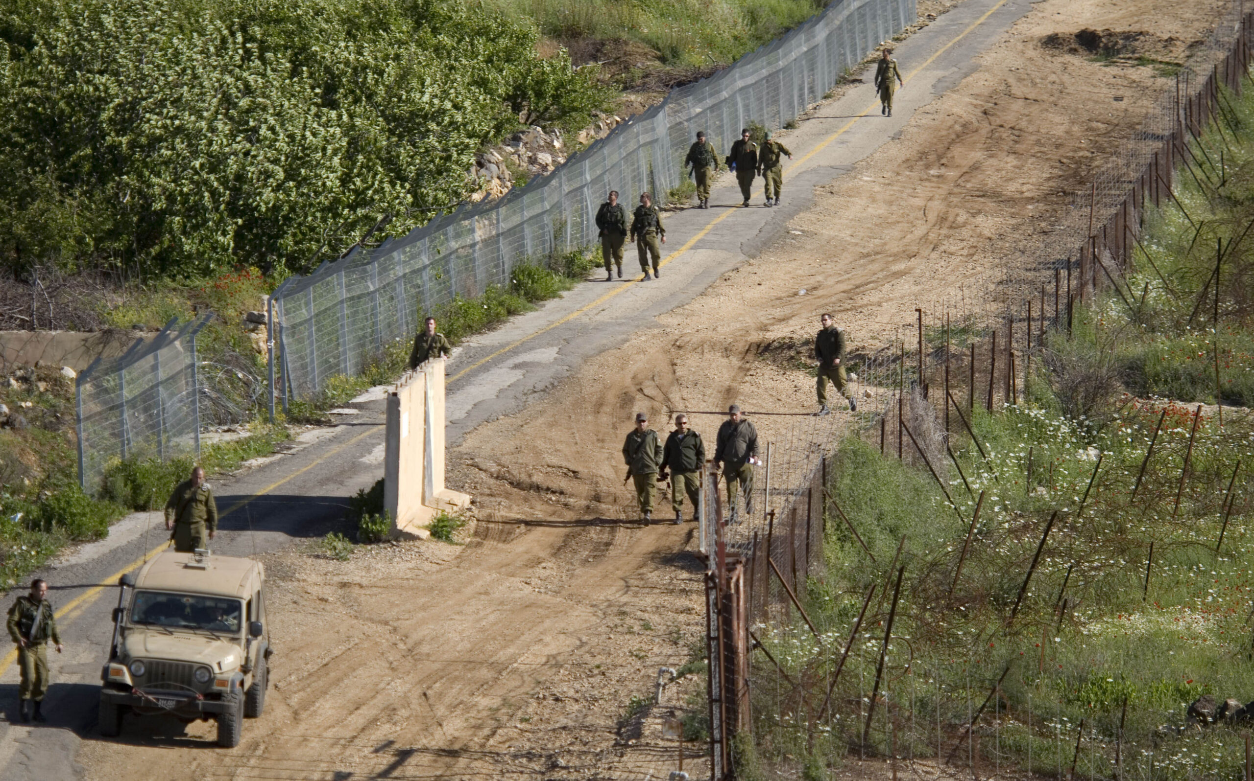 Israeli troops search for gaps in the fence along the border between Israel and Syria near the village of Majdal Shams in the Golan Heights.(AP/Ariel Schalit)