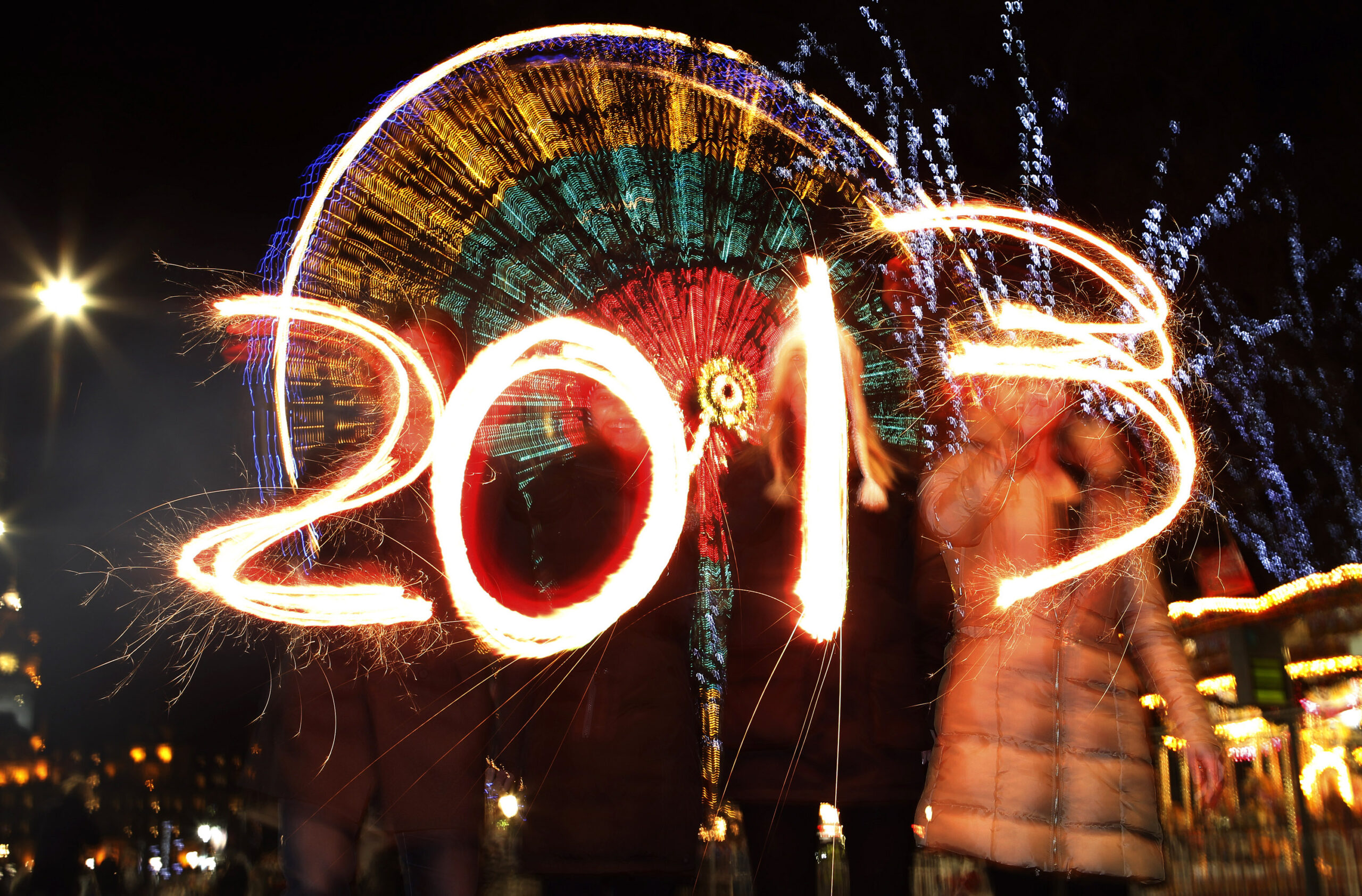 Revellers write the number 2013 using sparklers during the Hogmanay (New Year) street party celebrations in Edinburgh, Scotland (David Moir/Reuters)