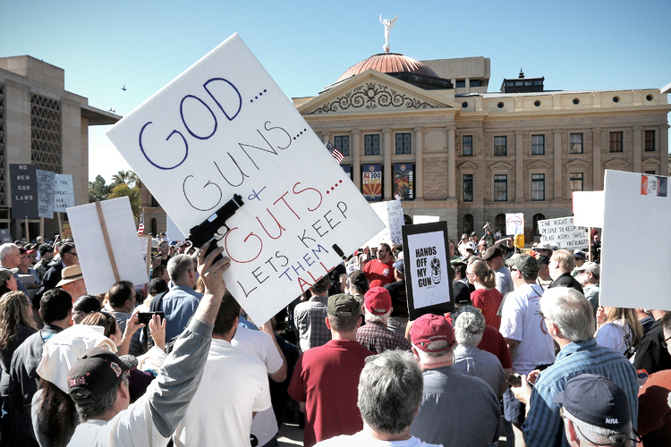 Gun rights supporters stand outside the Capitol Sat, Jan. 19, 2013 in Phoenix during a Guns Across America rally. (AP/Matt York)