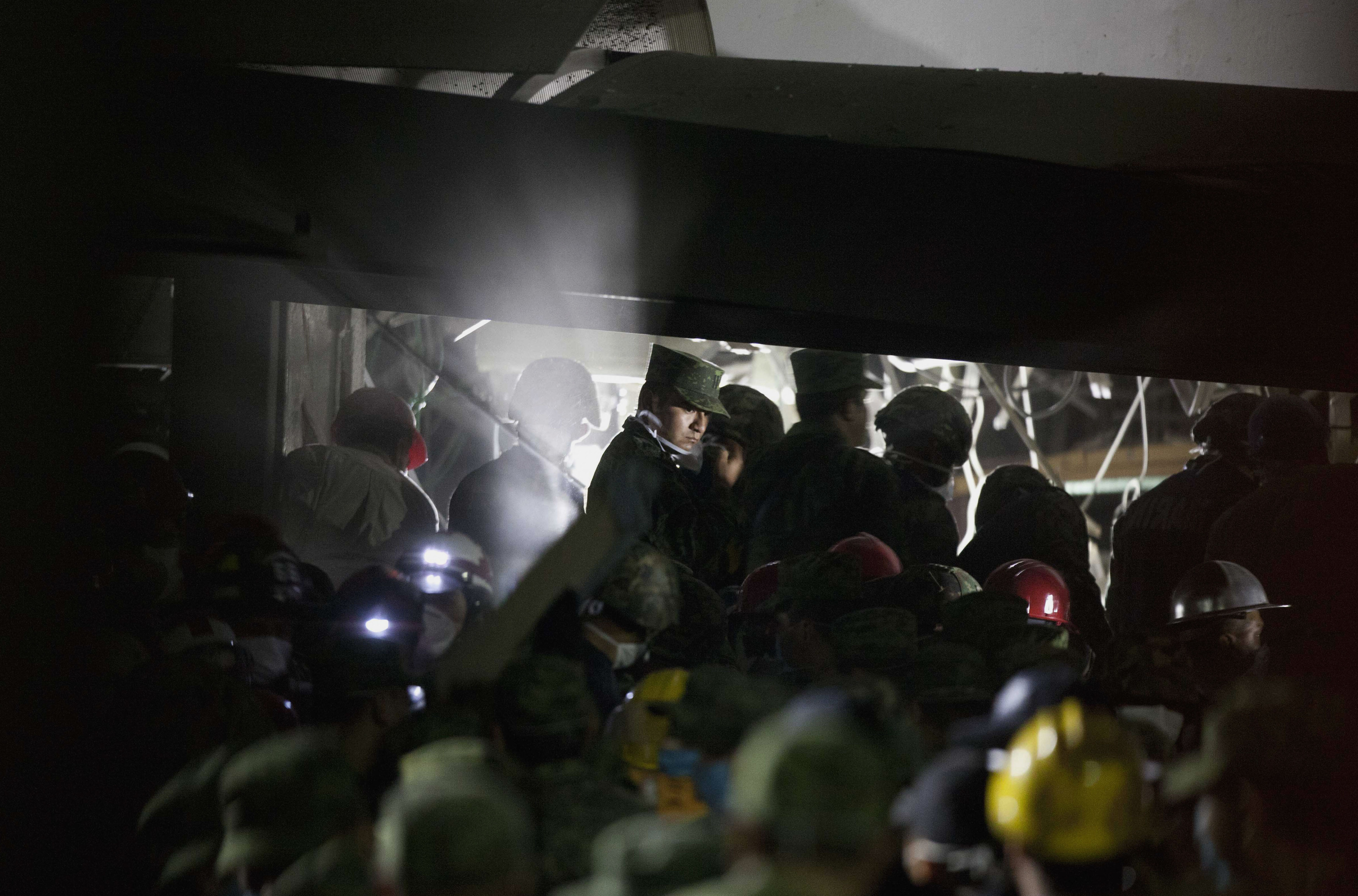 Rescue workers, firefighters and military search for survivors at the site of an explosion in a building at Mexico's state-owned oil company PEMEX complex. (AP/Eduardo Verdugo)
