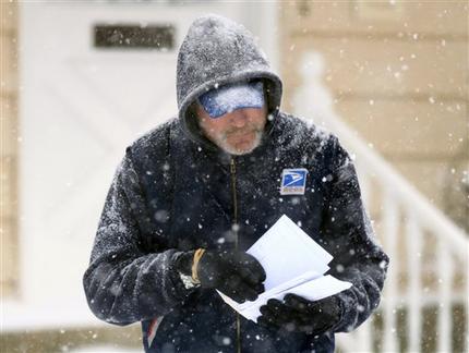 U. S. Post Office letter carrier Tim Bell delivers the mail during a snow storm in Havertown, Pa. (AP Photo/Jacqueline Larma)