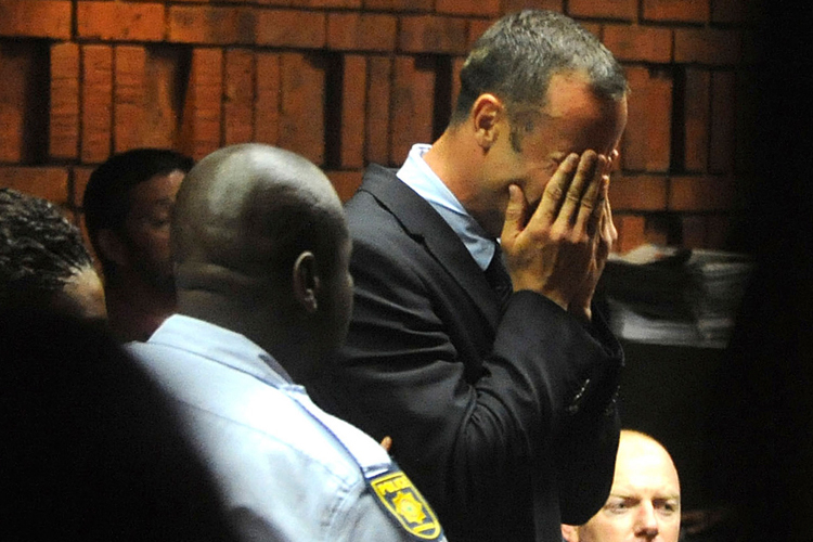 Olympic sprinter Oscar Pistorius weeps in court during his bail hearing in the murder case of Reeva Steenkamp. Pistorius allegedly shot his girlfriend on Valentine's Day. (AP/Antione de Ras)