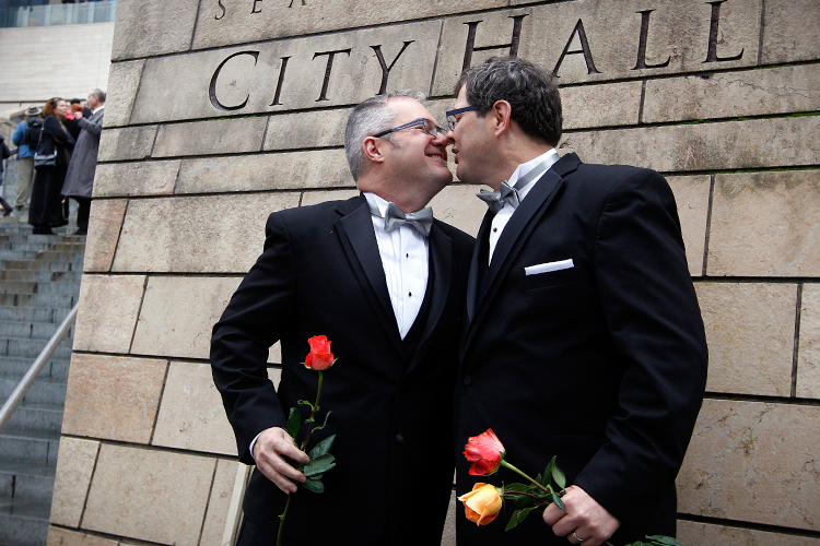Terry Gilbert, left, kisses his husband Paul Beppler after wedding at Seattle City Hall, Dec. 9, 2012. (AP/Elaine Thompson)