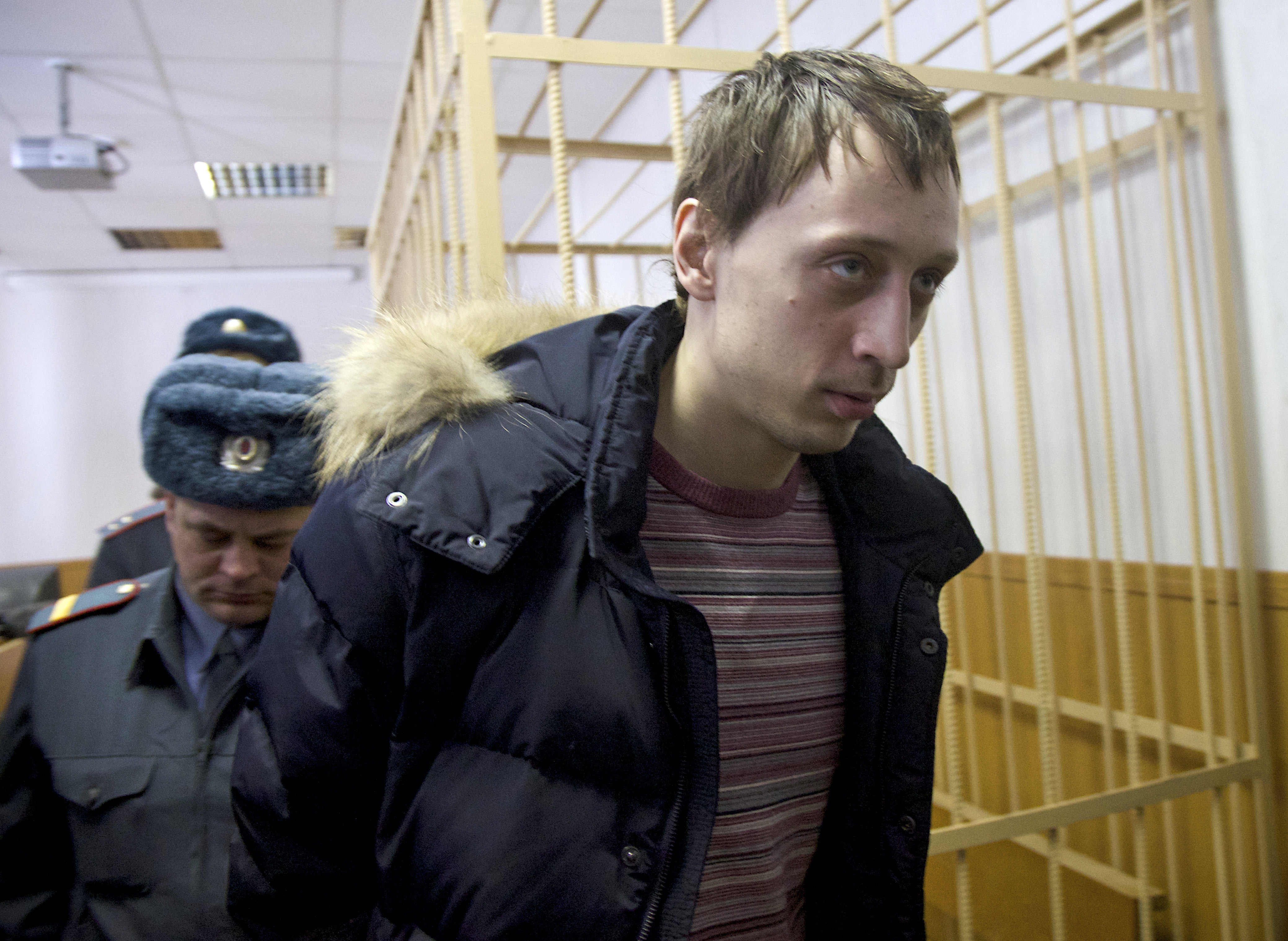 Pavel Dmitrichenko, foreground, is escorted out of a courtroom in Moscow, Russia, on Thursday, March 7, 2013. (AP/Ivan Sekretarev)