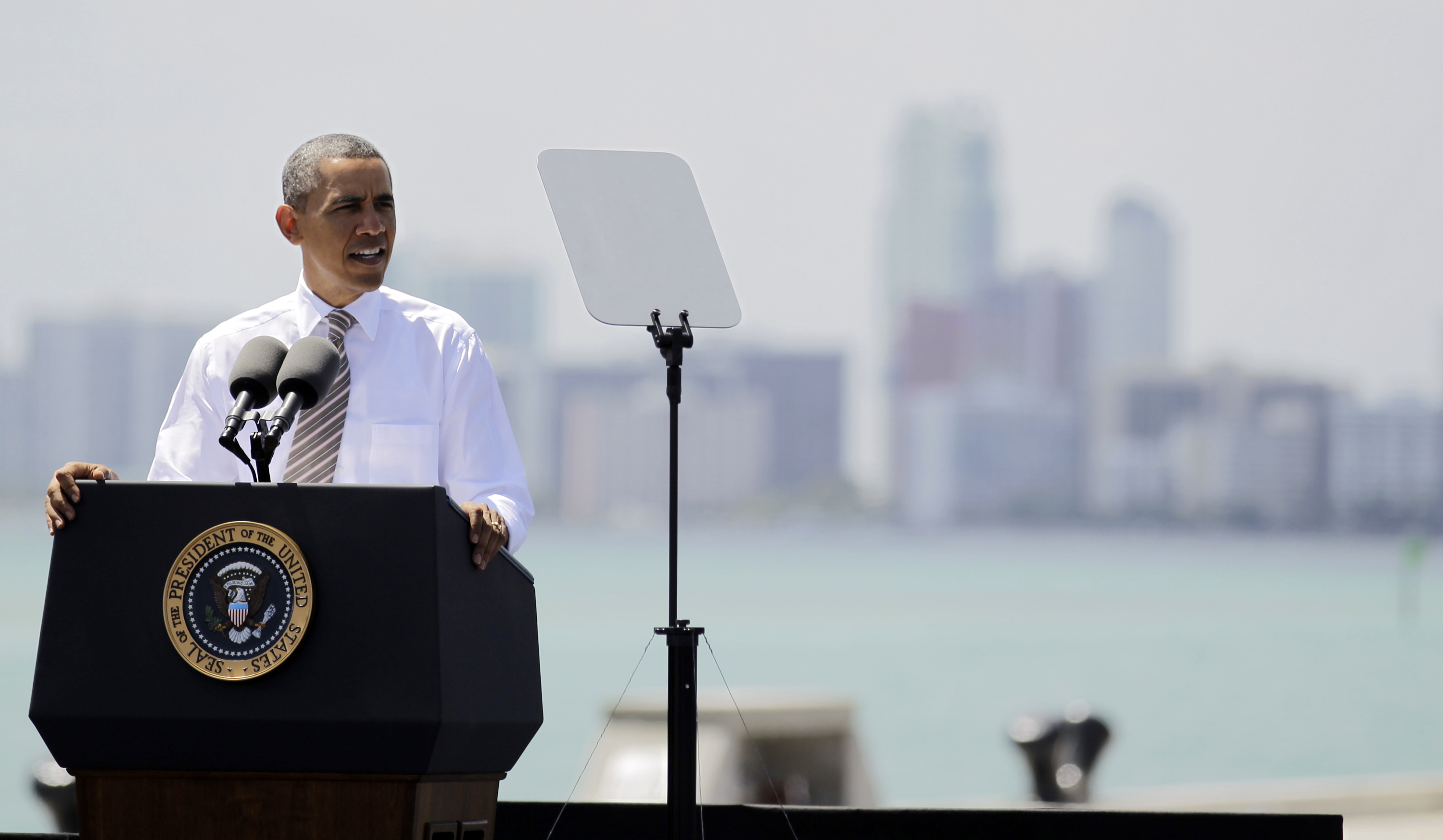 President Barack Obama speaks at a port in Miami, Friday, March 29, 2013, promoting a plan to create construction and other jobs by attracting private investment in roads and other public works projects. (AP/Luis M. Alvarez)