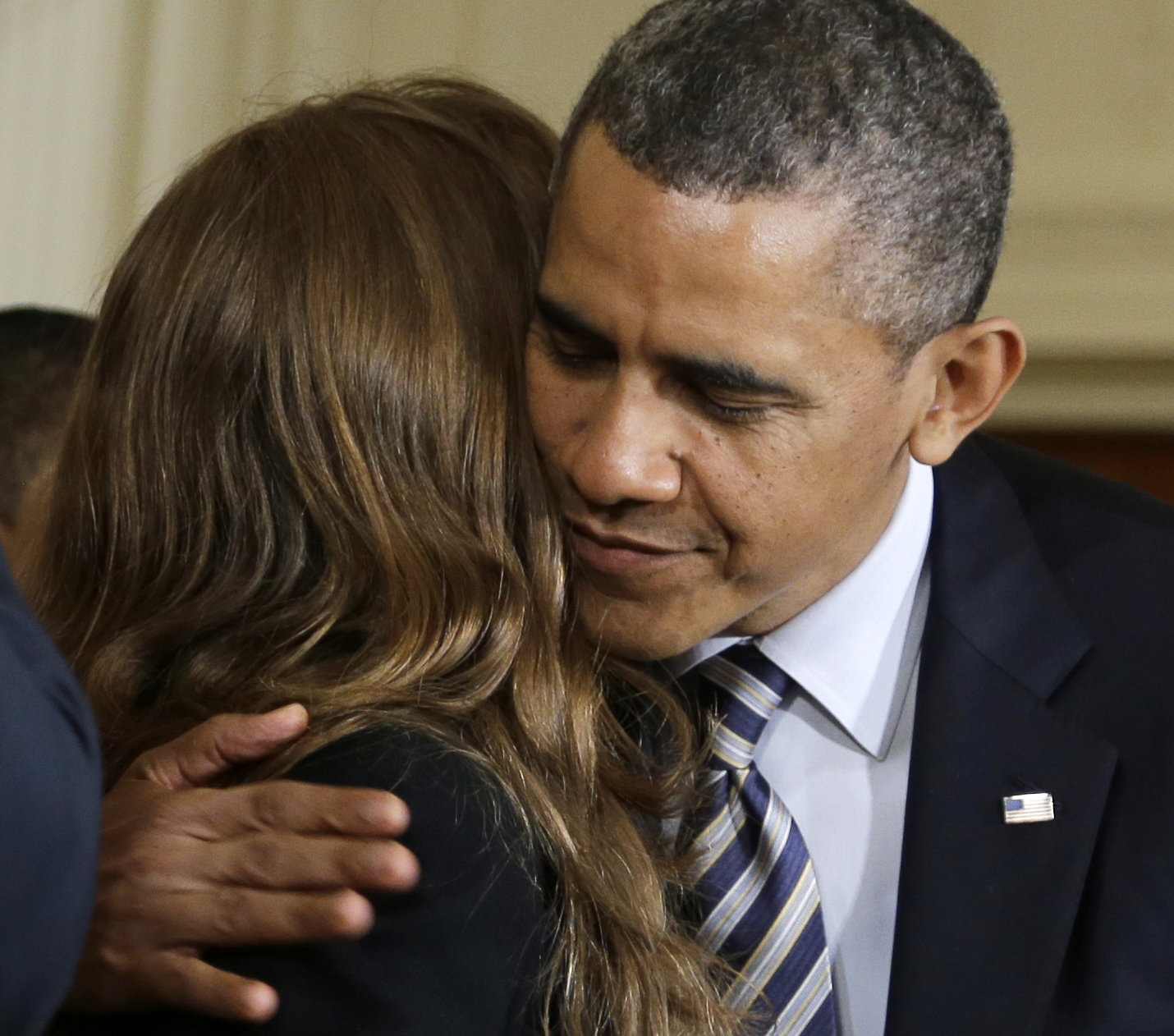 President Barack Obama hugs Katerina Rodgaard, a Maryland dance instructor who knew one of the victims of the Virginia Tech shootings, after she introduced him in the East Room of the White House in Washington, Thursday, March 28, 2013. (AP/Carolyn Kaster)