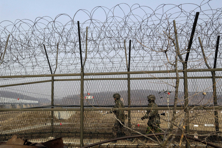 South Korean army soldiers patrol along a barbed-wire fence at the Imjingak Pavilion near the border village of Panmunjom. (AP Photo/Lee Jin-man)