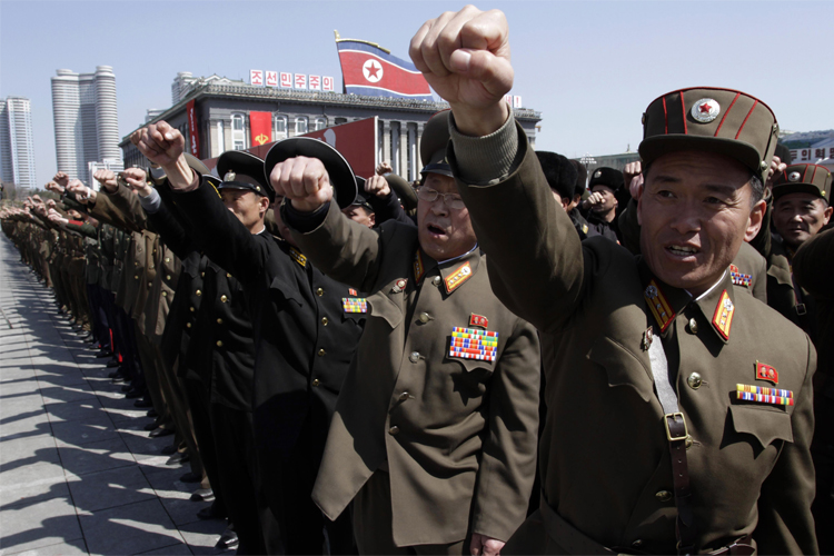 North Korean army officers punch the air as they chant slogans during a rally at Kim Il Sung Square in downtown Pyongyang, North Korea, Friday, March 29, 2013. Tens of thousands of North Koreans turned out for the mass rally at the main square in Pyongyang in support of their leader Kim Jong Un's call to arms. (AP Photo/Jon Chol Jin) (Jon Chol Jin)