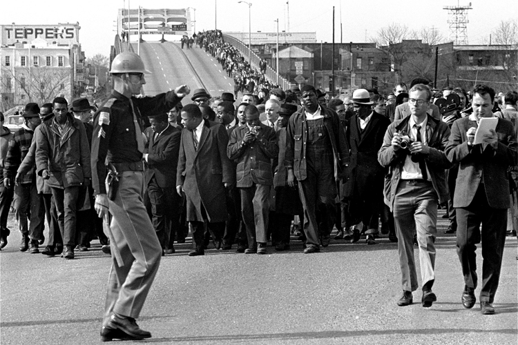 Demonstrators, including Dr. Martin Luther King Jr., stream over an Alabama River bridge at the city limits of Selma, Ala., on March 10, 1965, during a voter rights march. (AP)