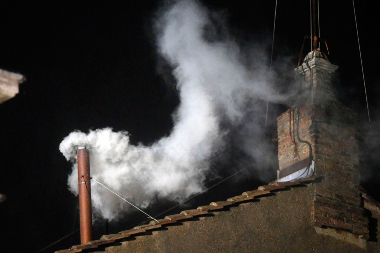 White smoke emerges from the chimney on the roof of the Sistine Chapel, in St. Peter's Square at the Vatican, Wednesday, March 13, 2013. The white smoke indicates that the new pope has been elected. (AP/Gregorio Borgia)