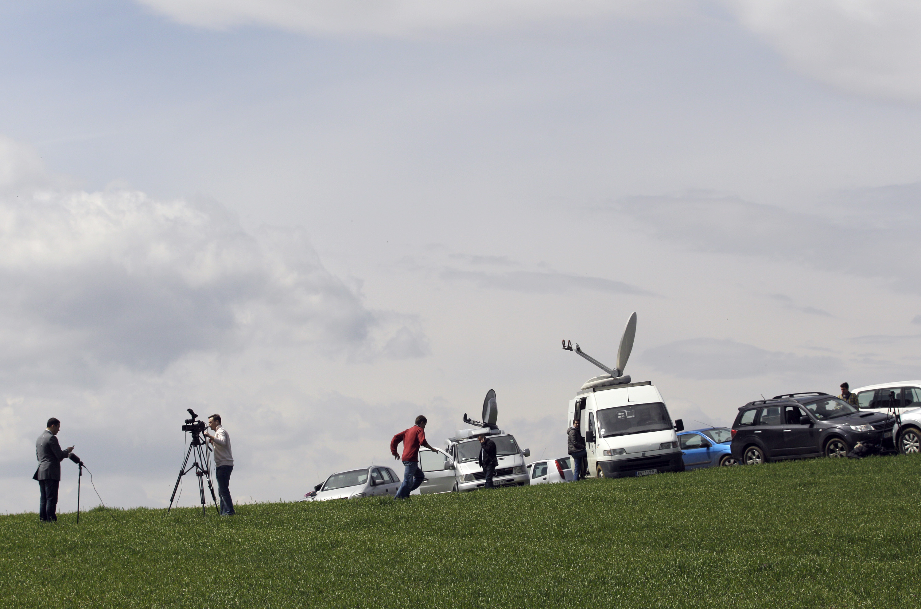 Journalists are seen in the village of Velika Ivanca, Serbia, Tuesday, April 9, 2013. (AP/Darko Vojinovic)