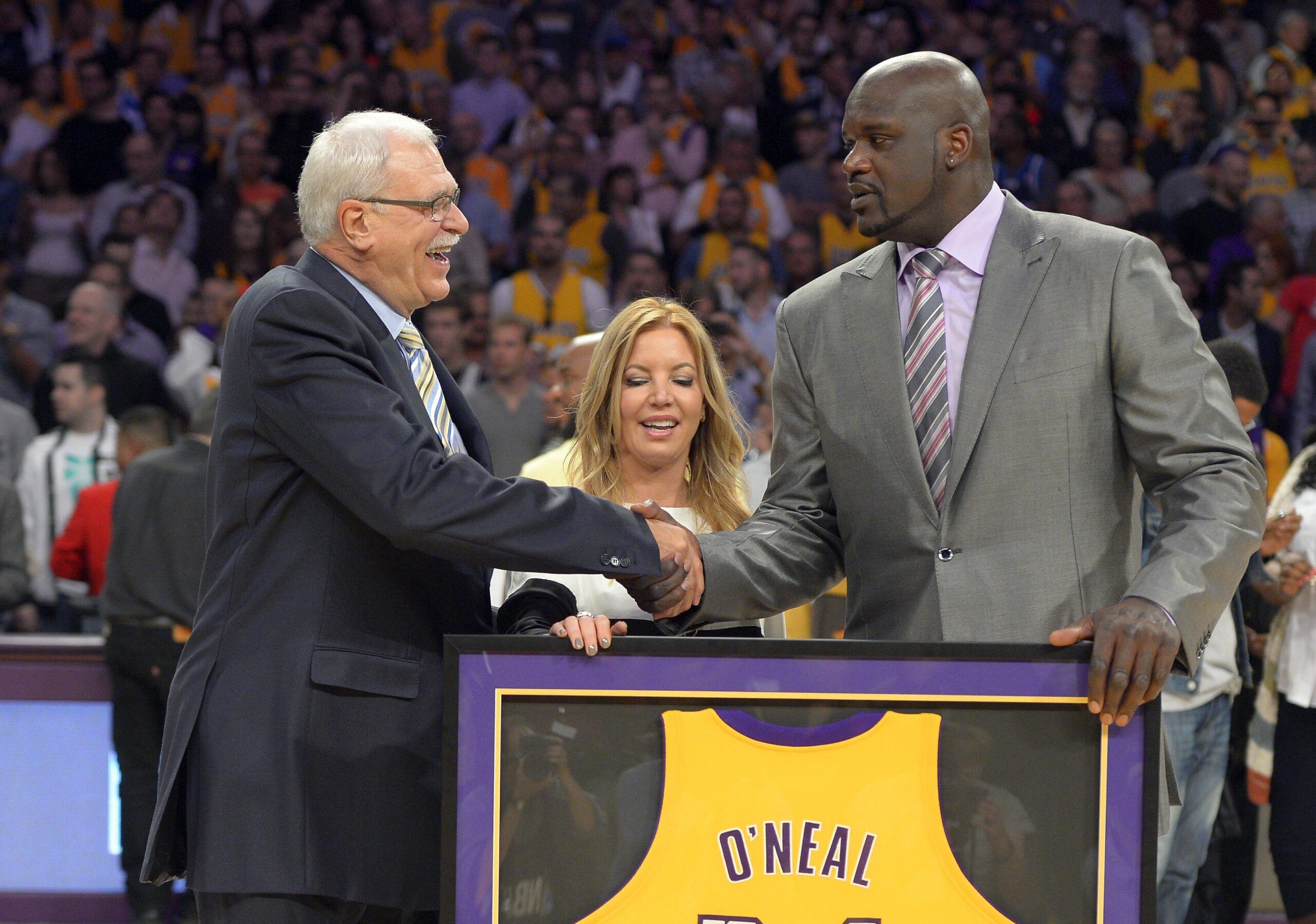 Former Los Angeles Lakers center Shaquille O'Neal, right, shakes hands with former Lakers head coach Phil Jackson (AP/Mark J. Terrill)