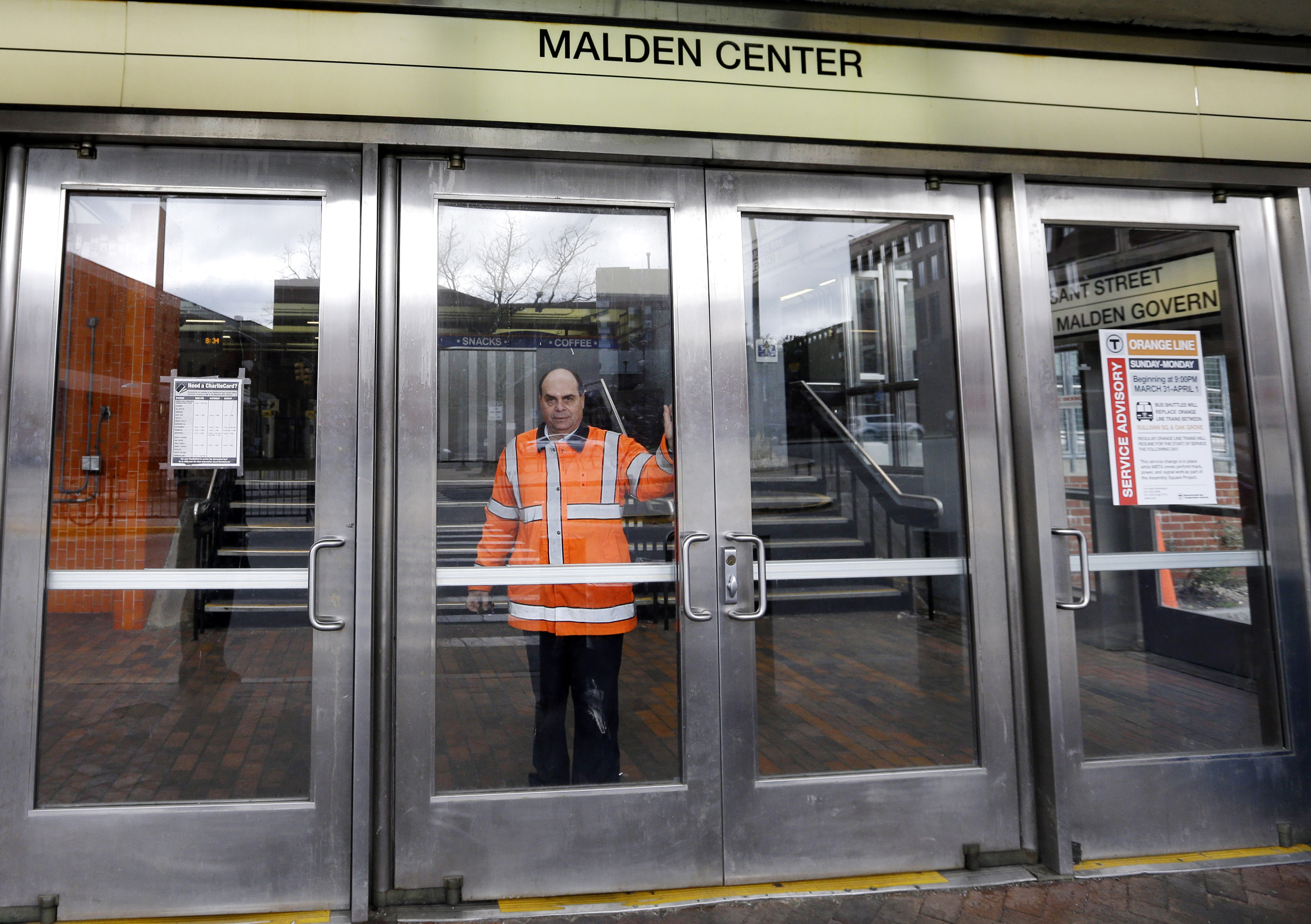 An MBTA transit official closes a door at Malden Center station in Malden, Mass. (AP/Elise Amendola)