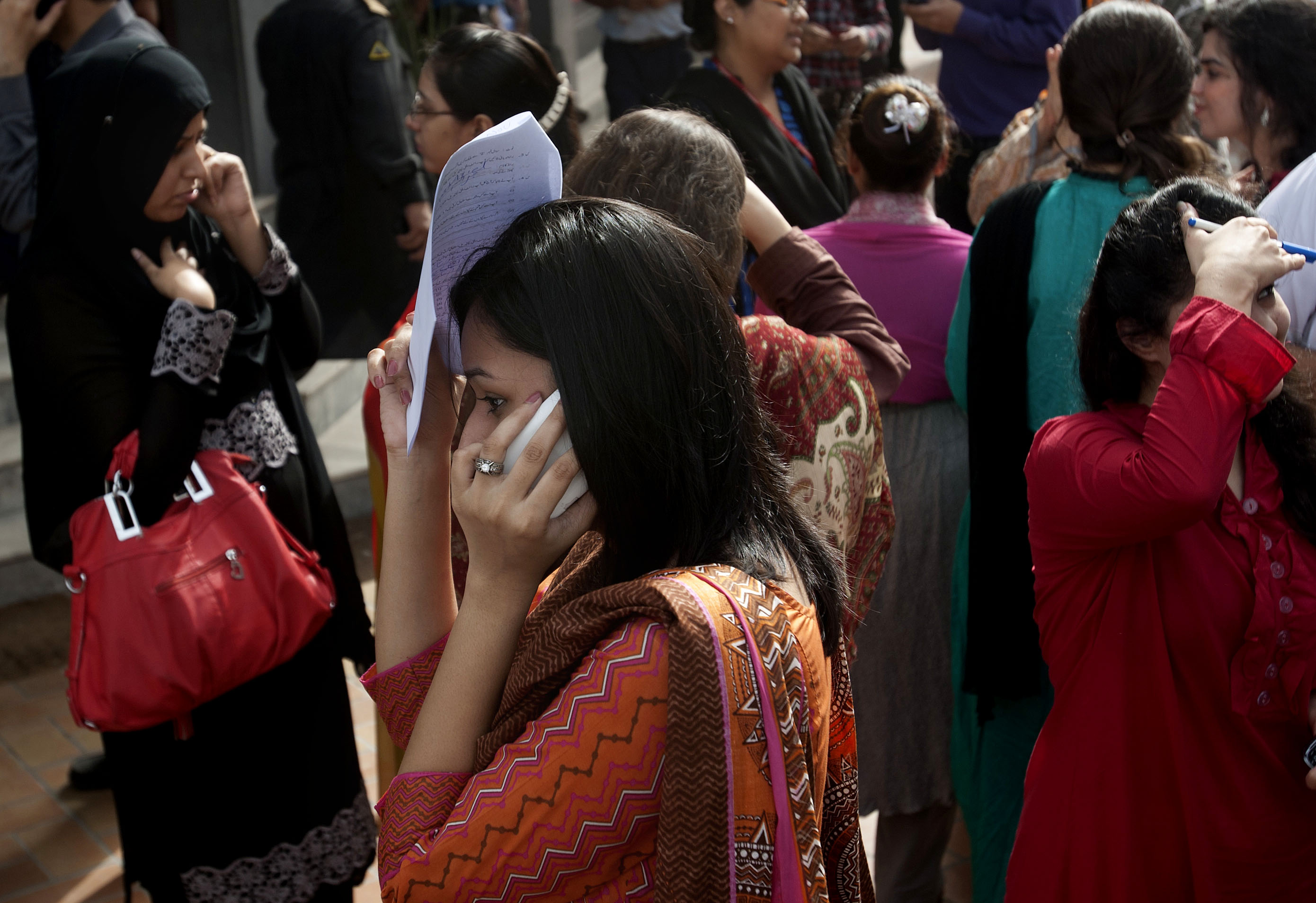 People evacuate buildings after a major earthquake hit Karachi, Pakistan, Tuesday, April 16, 2013. (AP/Shakil Adil)