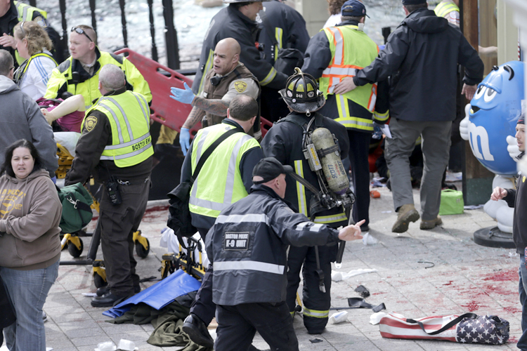 Medical workers aid injured people at the finish line of the 2013 Boston Marathon following an explosion in Boston, Monday, April 15, 2013. (AP/Charles Krupa)