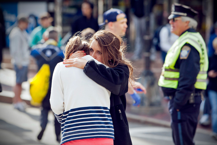 A woman comforts another, after explosions interrupted the 117th Boston Marathon in Boston, Massachusetts April 15, 2013. (Reuters/Dominick Reuter)