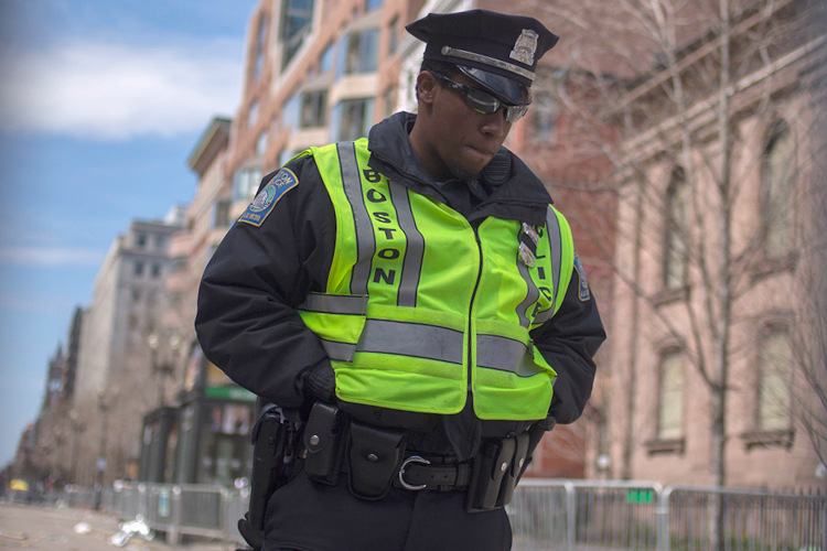 A Boston police officer stands inside the barricaded entrance at Boylston Street near the finish line of the Boston Marathon in Boston, Massachusetts April 16, 2013. (Reuters/Shannon Stapleton)