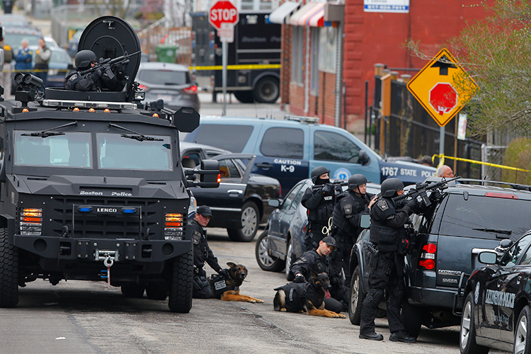 Police officers take position during a search for the Boston Marathon bombing suspects in Watertown, Massachusetts April 19, 2013. (Brian Snyder / Reuters)