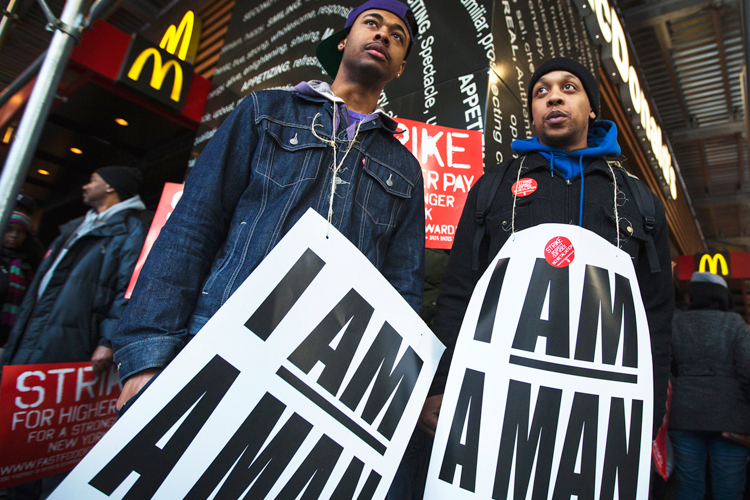Demonstrators protesting low wages and the lack of union representation in the fast food industry stand outside McDonald's in New York, April 4, 2013. (Reuters/Lucas Jackson)