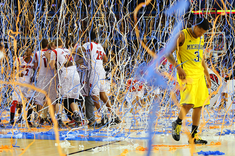 Michigan guard Trey Burke walks off the court after the NCAA tournament championship game, Monday, April 8, 2013. Louisville won 82-76. (AP/Curtis Compton)