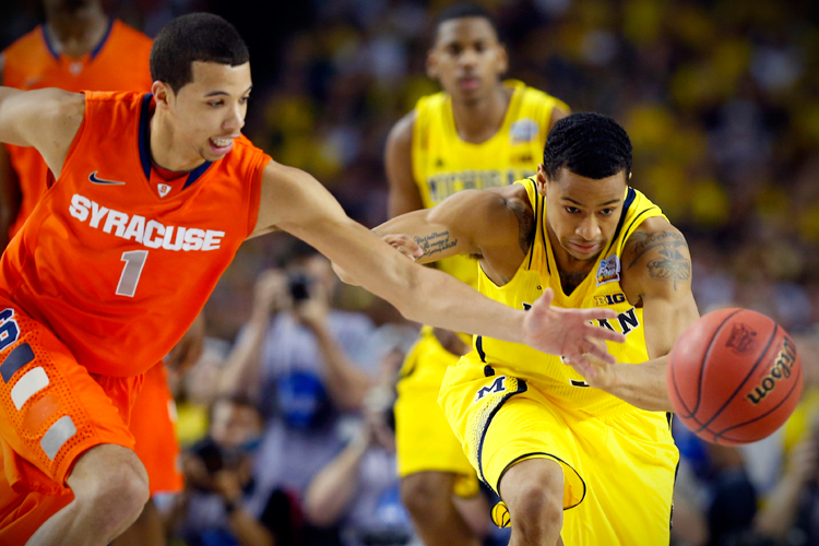 Syracuse's Michael Carter-Williams and Michigan's Trey Burke lunge for the ball during their Final Four game on April 6. (Reuters/Chris Keane)