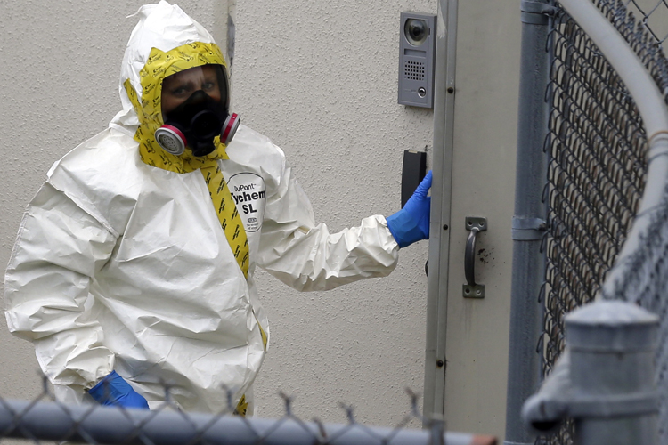 A Prince George's County, Md. firefighter dressed in a protective suit walks into a government mail screening facility in Hyattsville, Md., Wednesday, April 17, 2013. (AP/Alex Brandon)