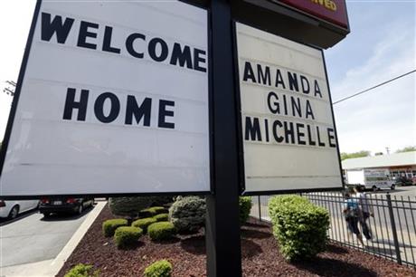 A welcome home sign is posted at a restaurant near a crime scene where three women were held captive for a decade in Cleveland, Ohio. (AP Photo/David Duprey)
