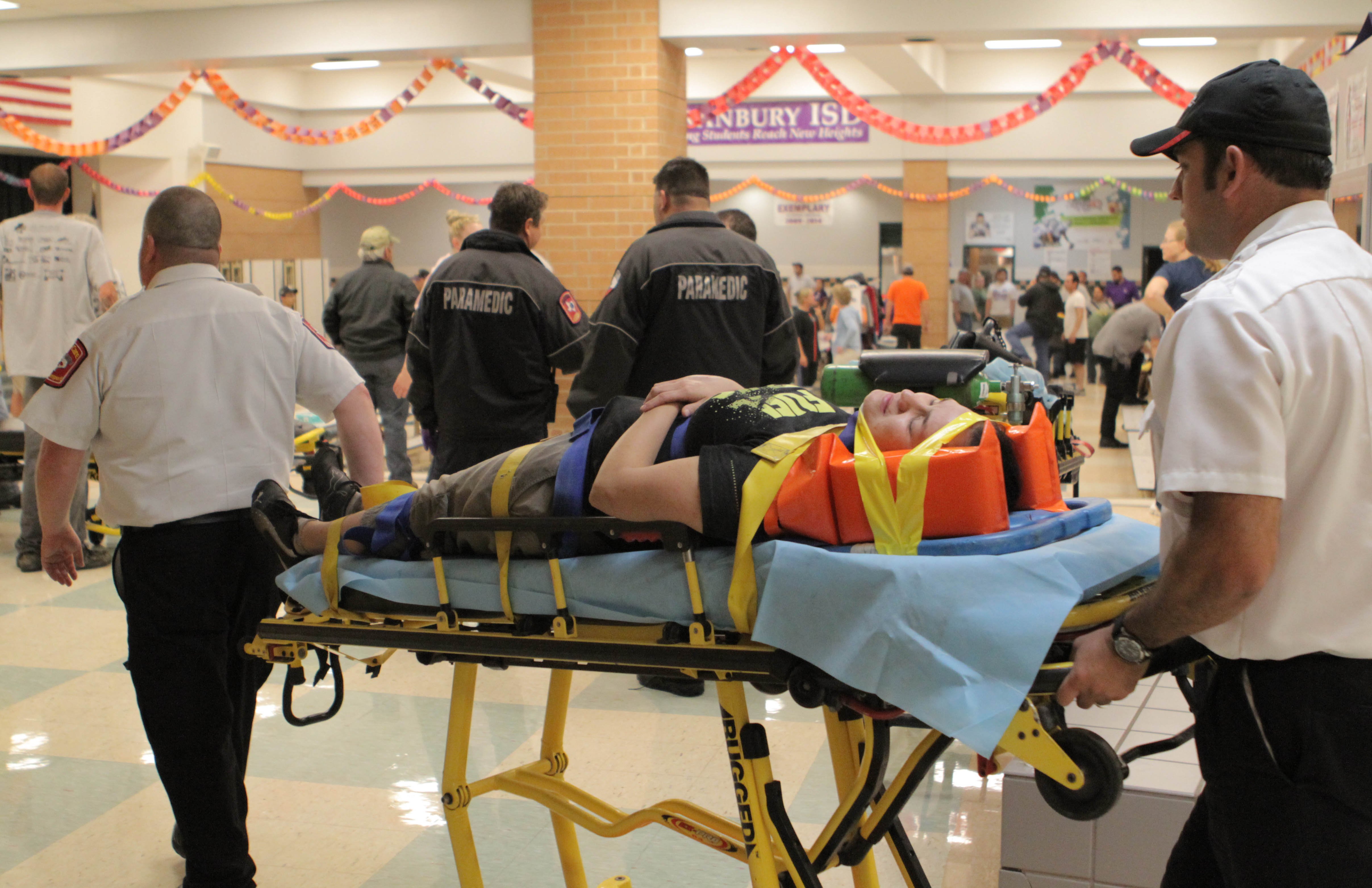 An unidentified injured person is carried to an ambulance in Granbury, Texas, on Wednesday May 15, 2013. (AP/Mike Fuentes)