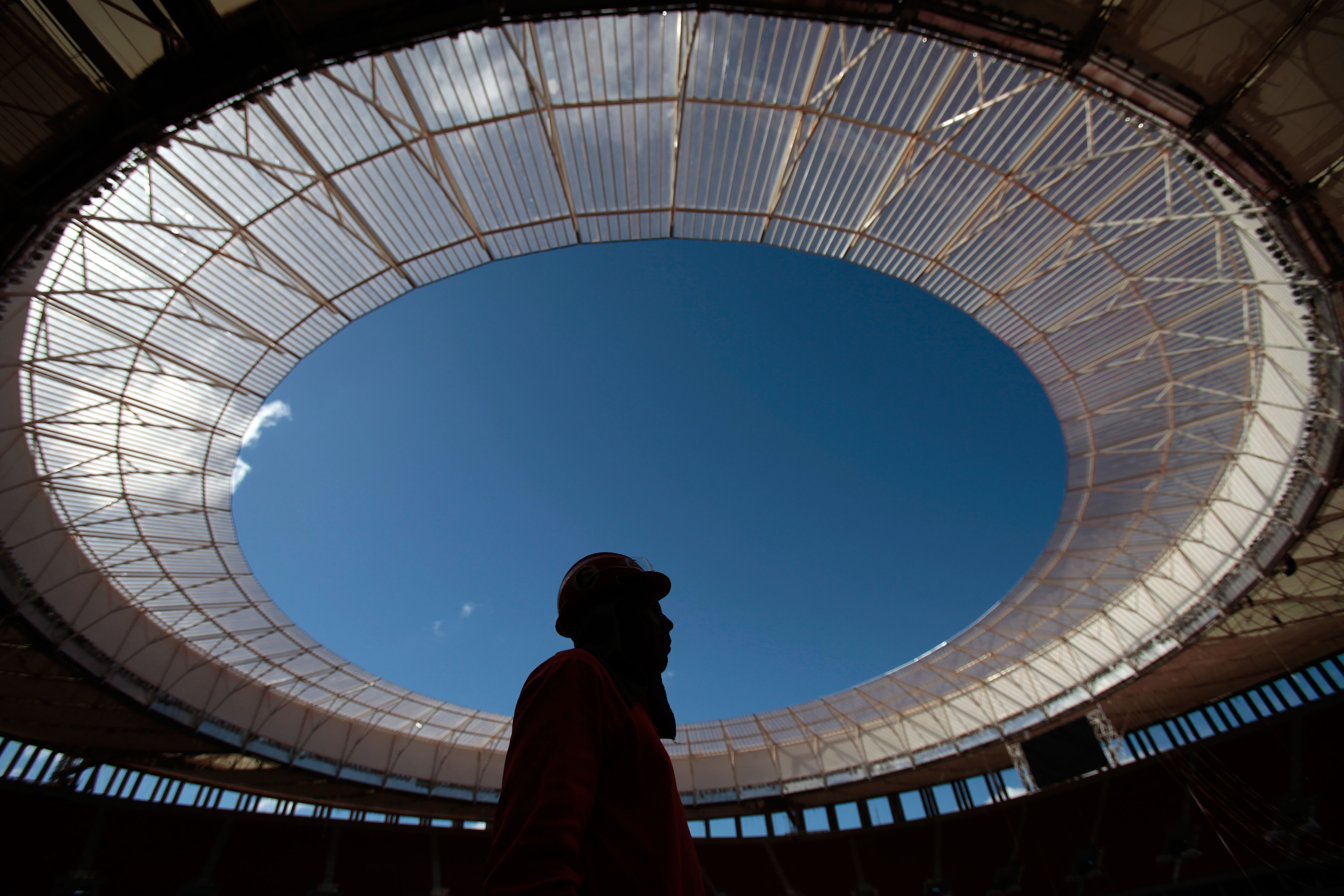 An employee stand inside the National Stadium Mane Garrincha in Brasilia, Brazil, Tuesday, May 14, 2013. (AP/Eraldo Peres)