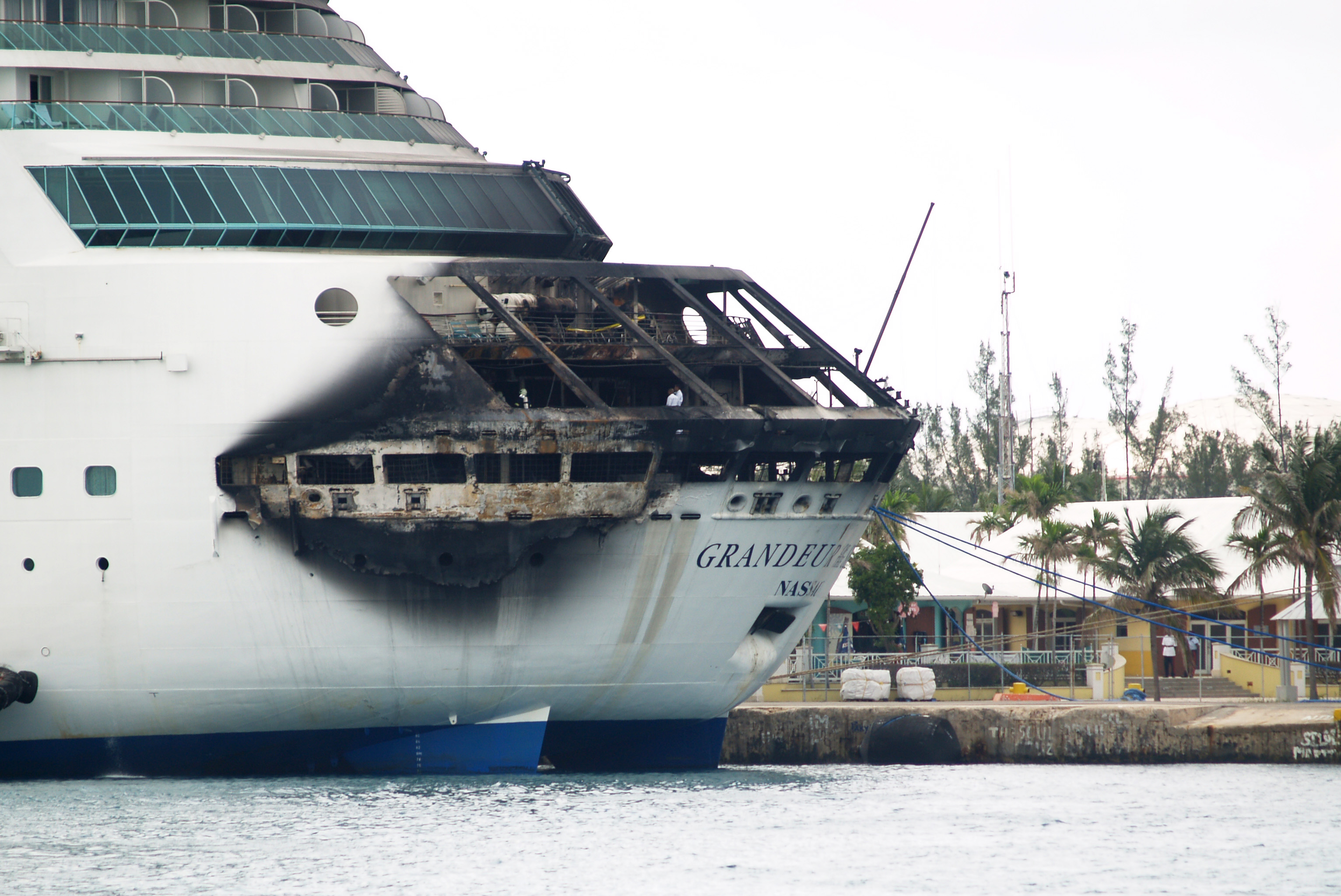 The fire-damaged exterior of Royal Caribbean's Grandeur of the Seas cruise ship is seen while docked in Freeport, Grand Bahama island, Monday, May 27, 2013. (AP/The Freeport News, Jenneva Russell)