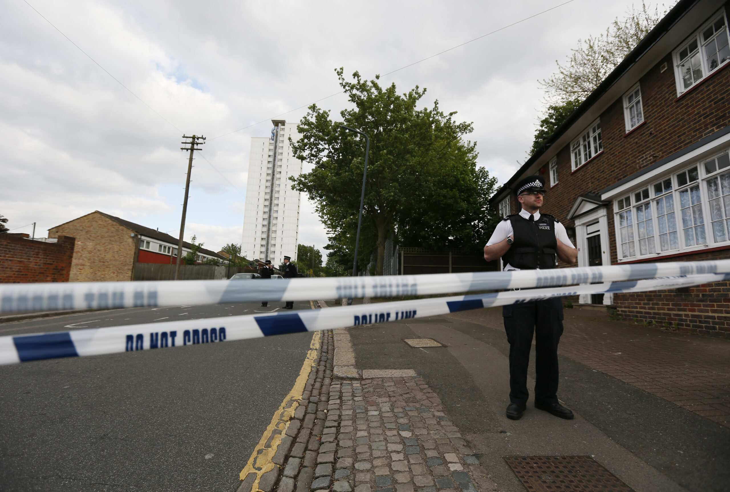 Police officers guard a cordon set up around a crime scene where one man was killed was killed in Woolwich, southeast London May 22, 2013. (REUTERS/Stefan Wermuth)