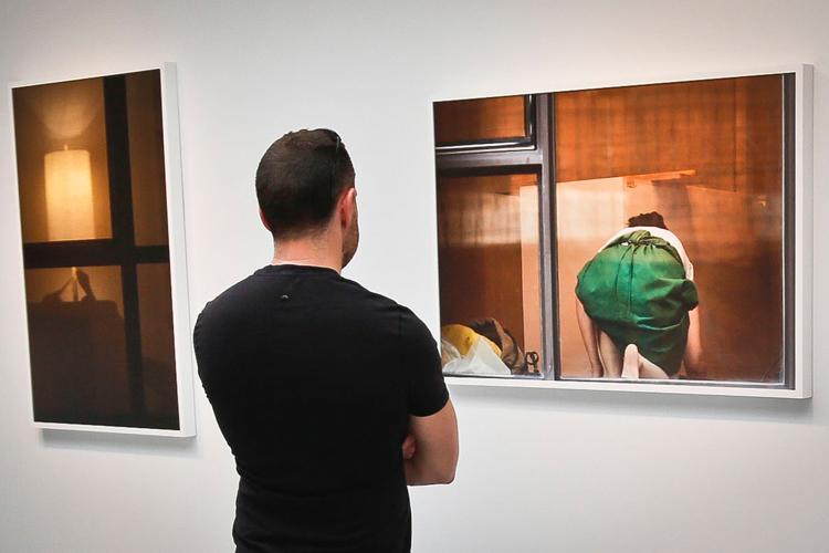 A visitor views the photography of Arne Svenson on Thursday, May 16, 2013 at the Julie Saul Gallery in New York. (AP/Bebeto Matthews)